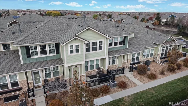 a front view of a house with glass windows and couches
