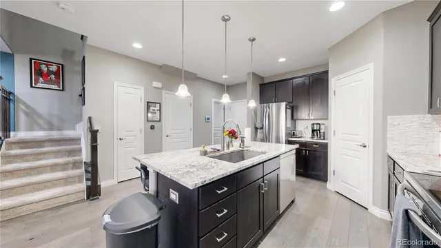 a kitchen with a stove a refrigerator and a sink