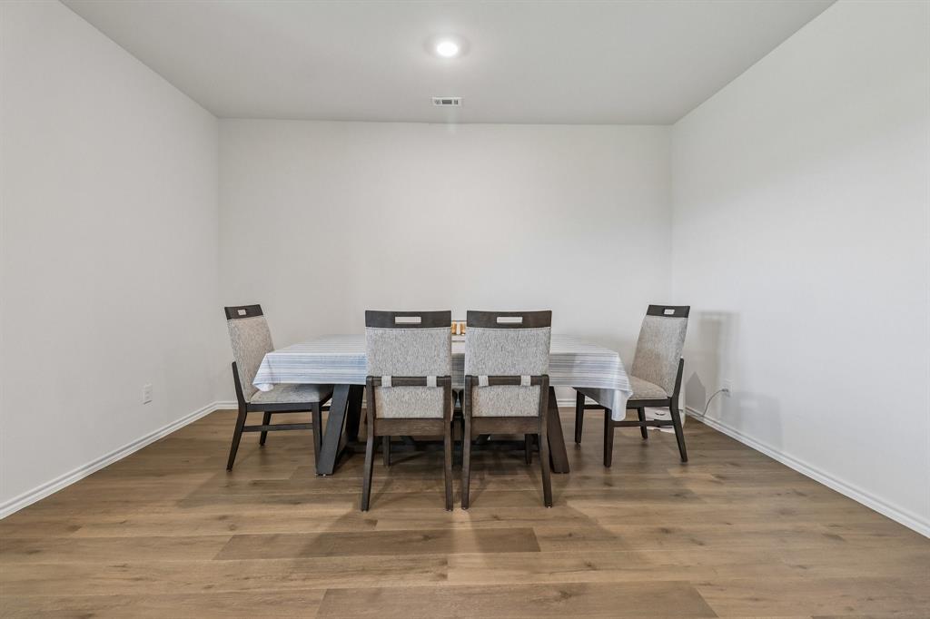 1453 Millstead Rill Road Caddo Mills, TX 75135 - Photo 13 of 40 Spacious room featuring wood-finish flooring, white baseboards, and a recessed ceiling light