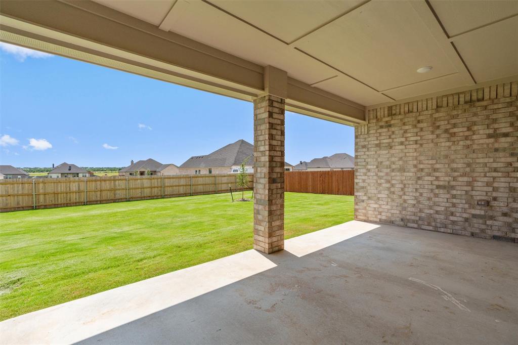 1341 Promised Land Road Hewitt, TX 76643 - Photo 25 of 29 Covered patio with a concrete slab, brick support columns, and an exposed brick exterior wall