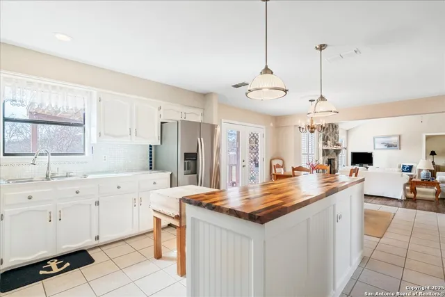 a kitchen with stainless steel appliances kitchen island granite countertop a sink a counter space cabinets and appliances