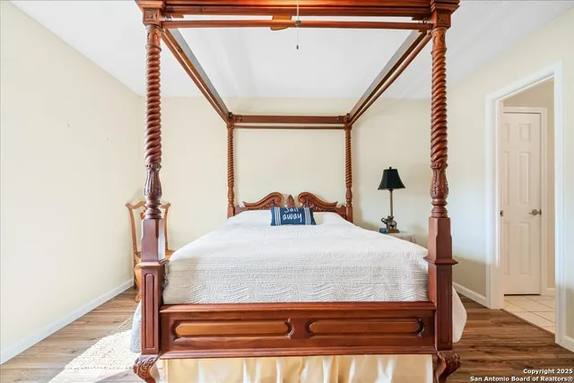 a bed sitting in a bedroom next to a window