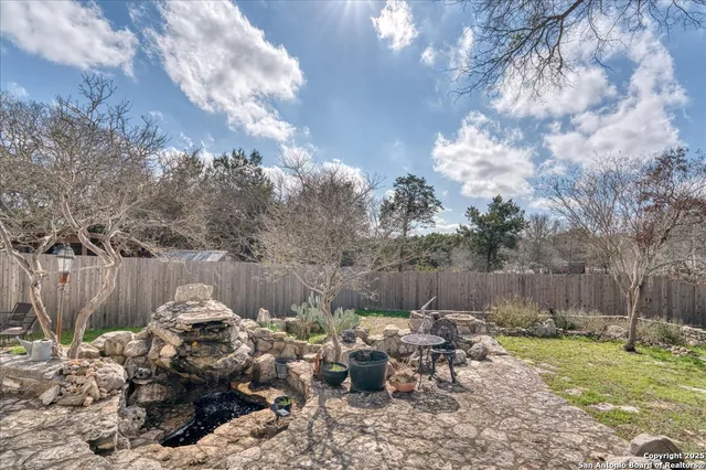 a backyard of a house with table and chairs