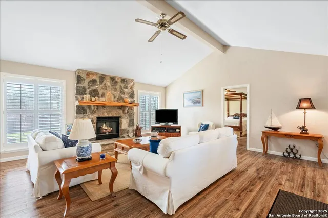 a living room with furniture fireplace and flat screen tv