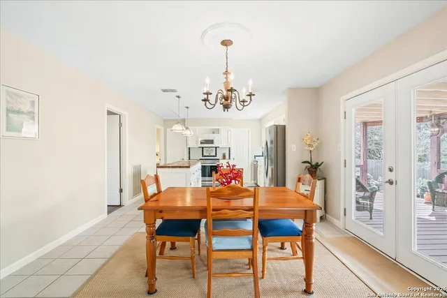 a view of a dining room with furniture and a chandelier
