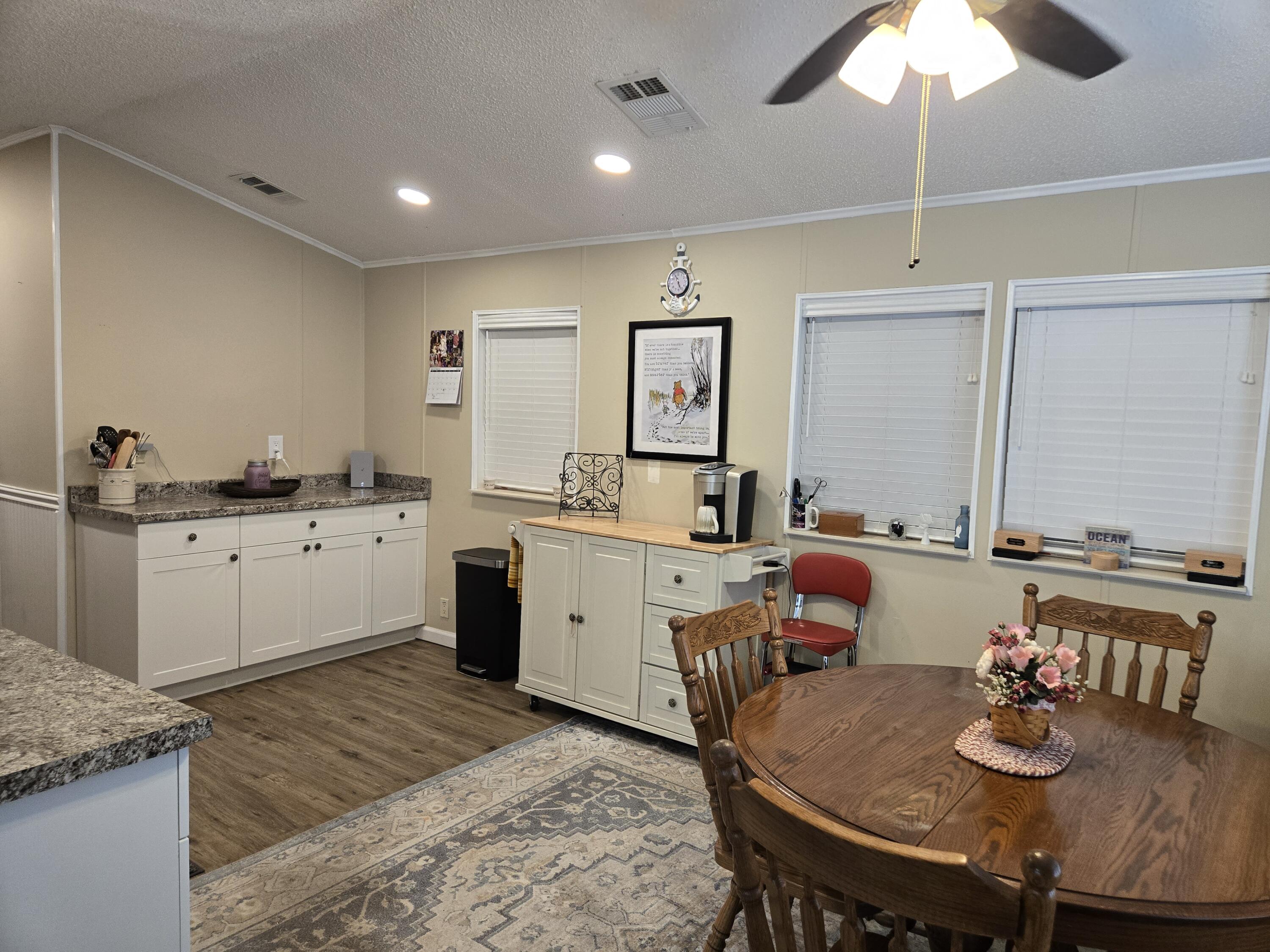12240 Southeast 138th Avenue, Unit 225 Okeechobee, FL 34974 - Photo 11 of 50 a large kitchen with a table and chairs