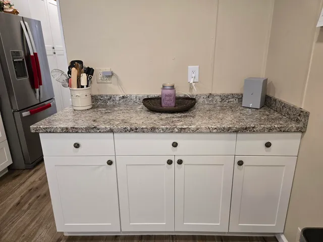 a kitchen with cabinets and white appliances