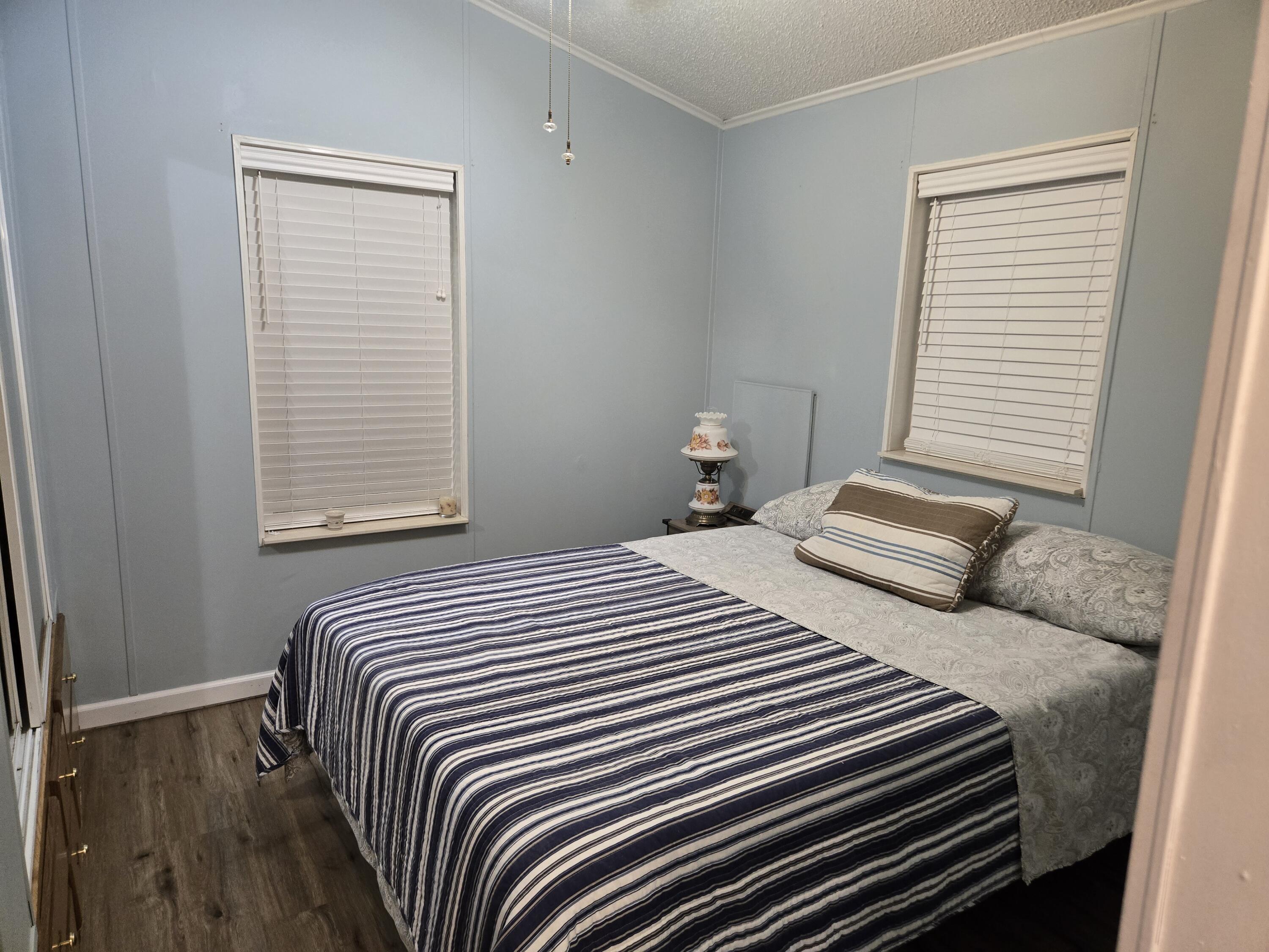 12240 Southeast 138th Avenue, Unit 225 Okeechobee, FL 34974 - Photo 19 of 50 a bedroom with a bed and a window
