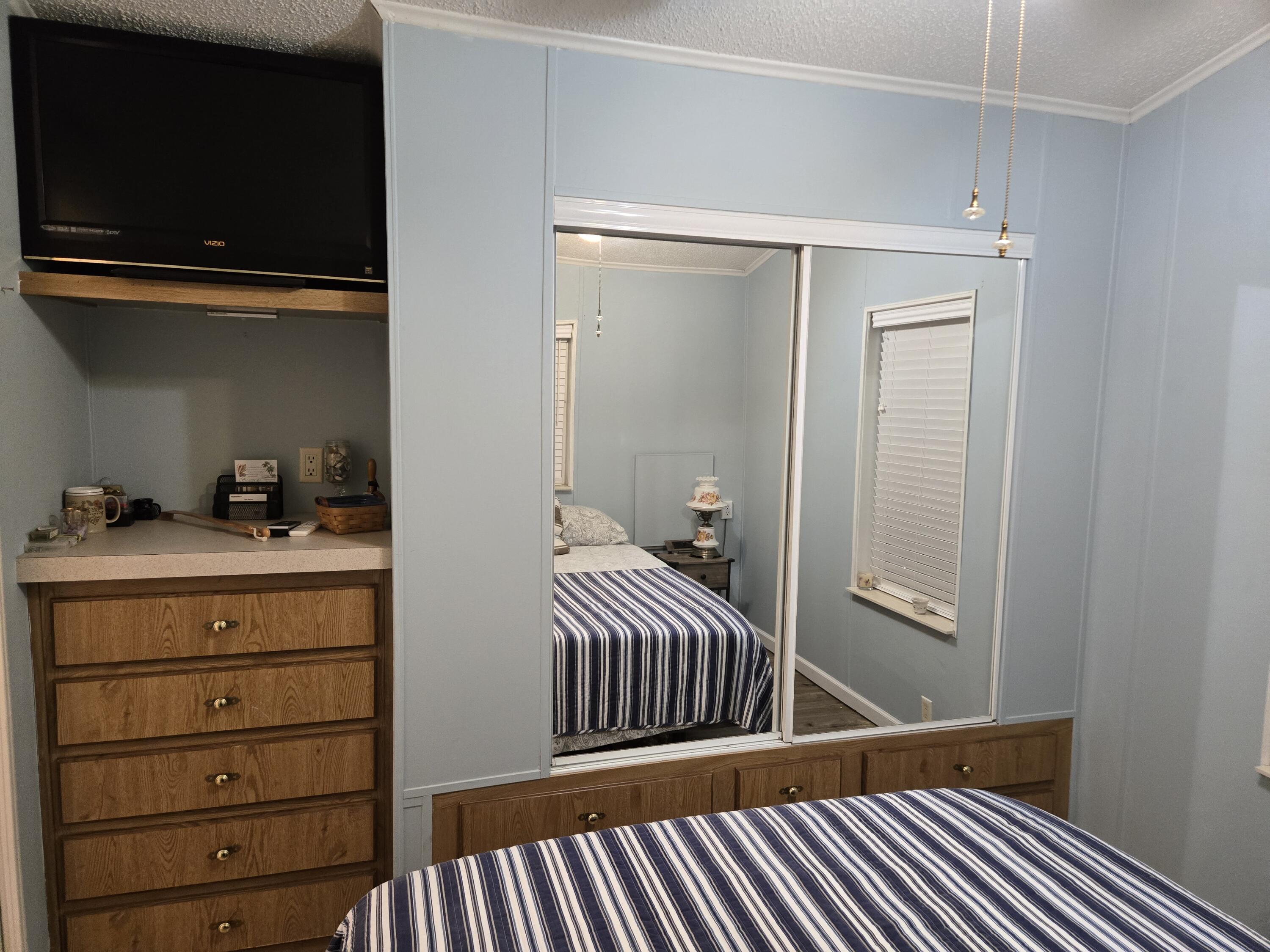 12240 Southeast 138th Avenue, Unit 225 Okeechobee, FL 34974 - Photo 20 of 50 a view of a hallway with a bedroom