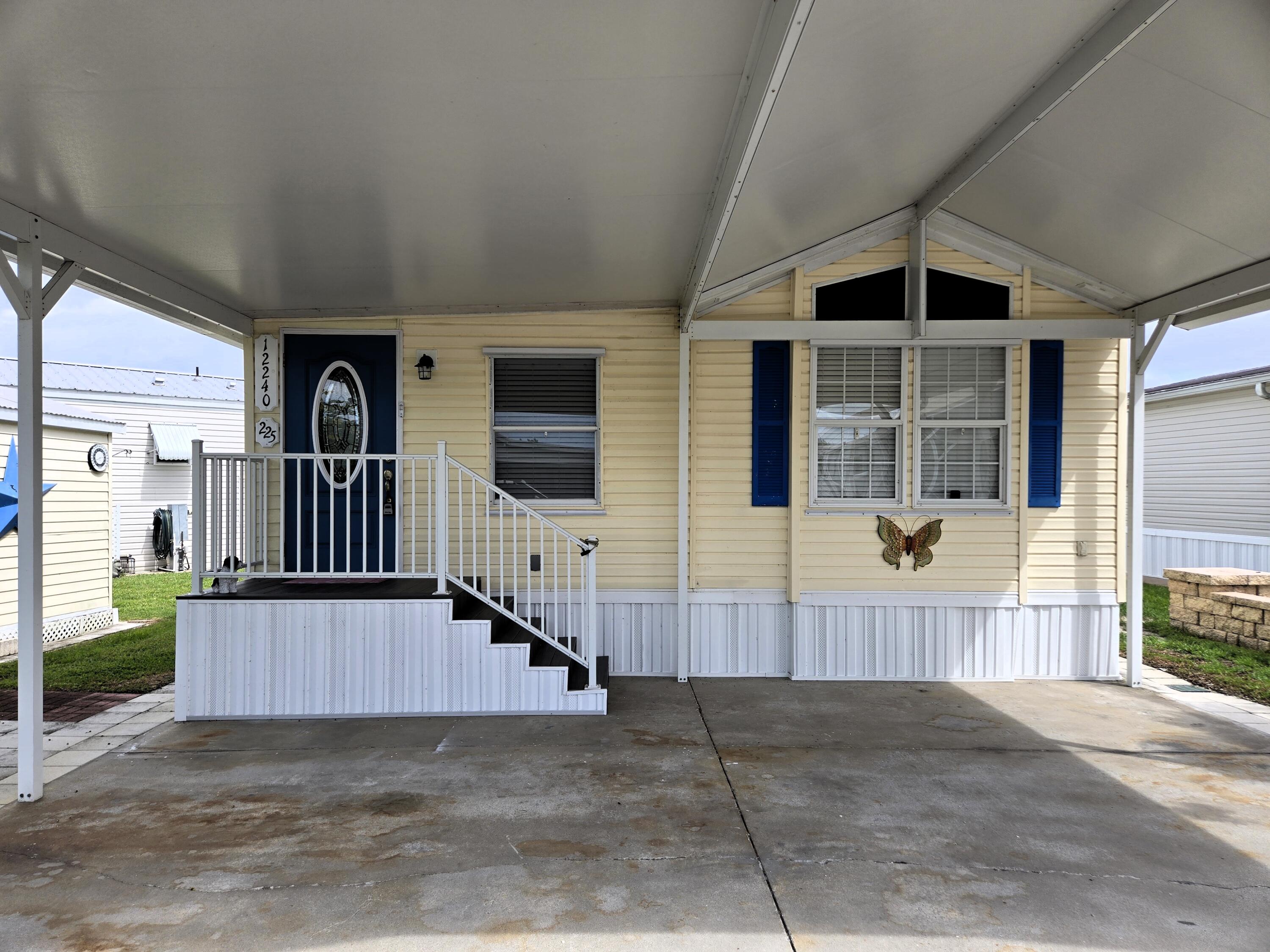 12240 Southeast 138th Avenue, Unit 225 Okeechobee, FL 34974 - Photo 2 of 50 a view of a house with a porch