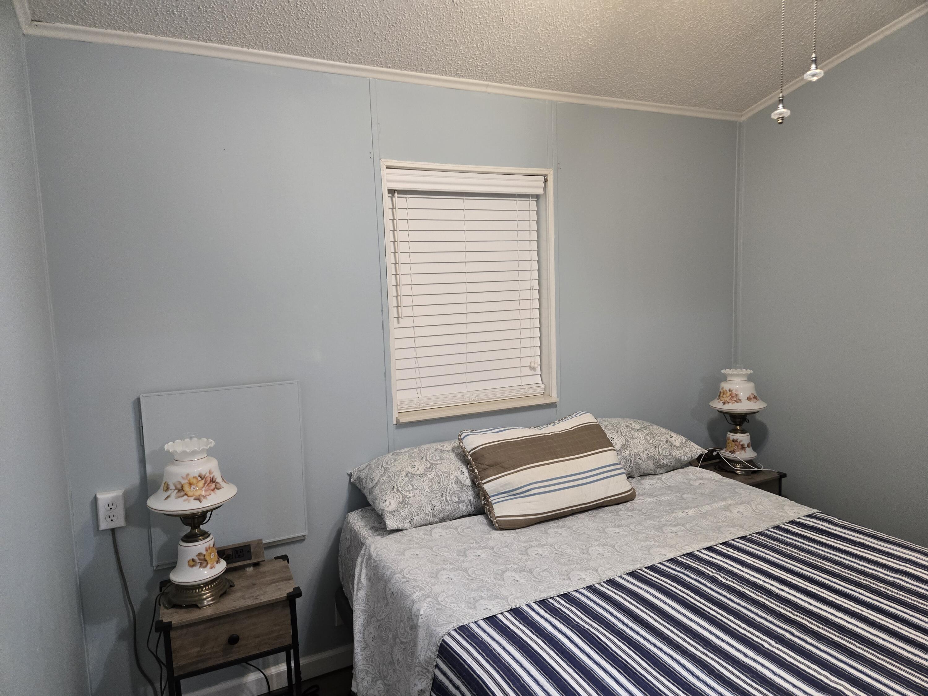 12240 Southeast 138th Avenue, Unit 225 Okeechobee, FL 34974 - Photo 21 of 50 a bedroom with a bed and a window