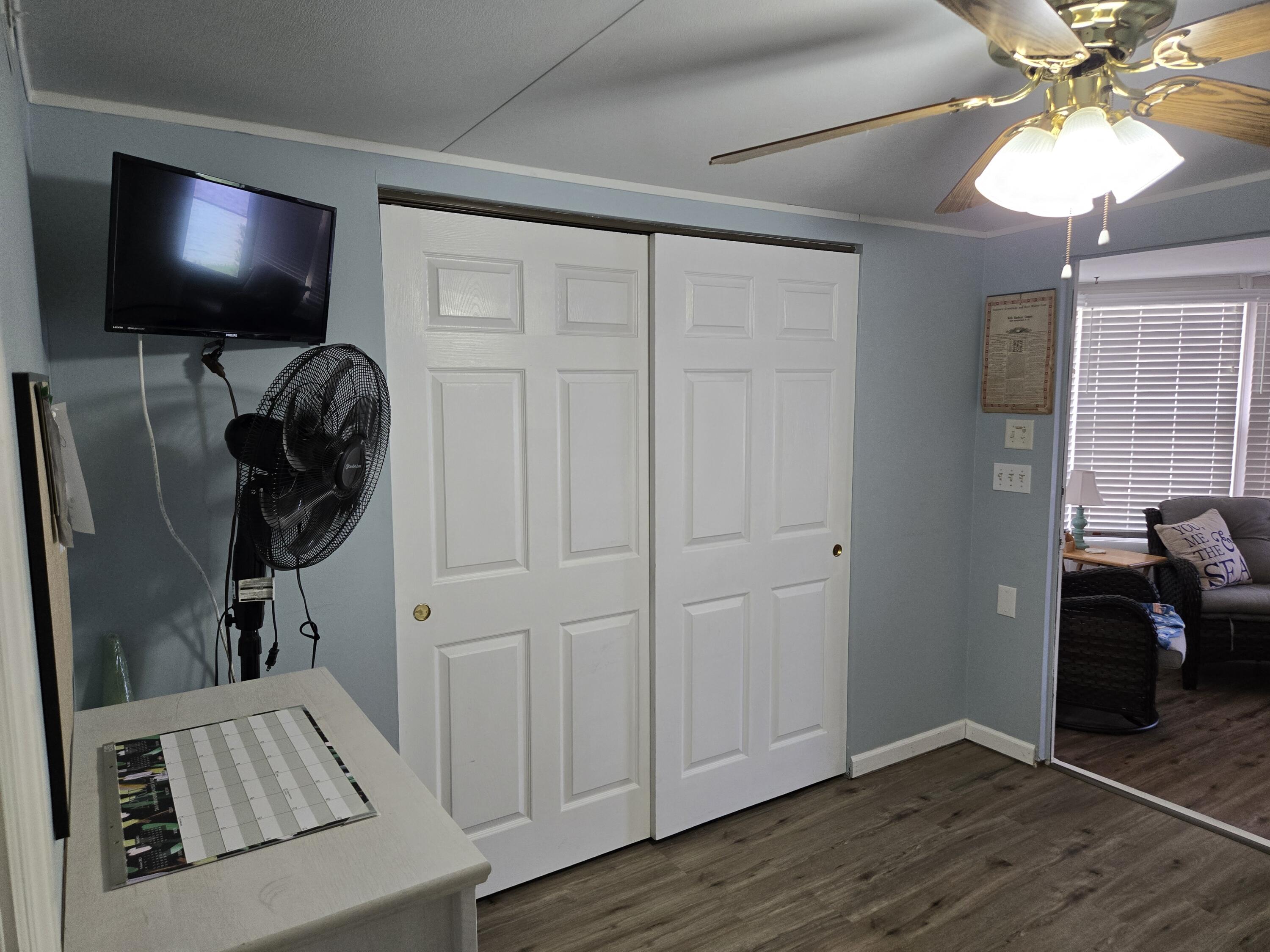 12240 Southeast 138th Avenue, Unit 225 Okeechobee, FL 34974 - Photo 25 of 50 a view of a livingroom with entryway and wooden floor