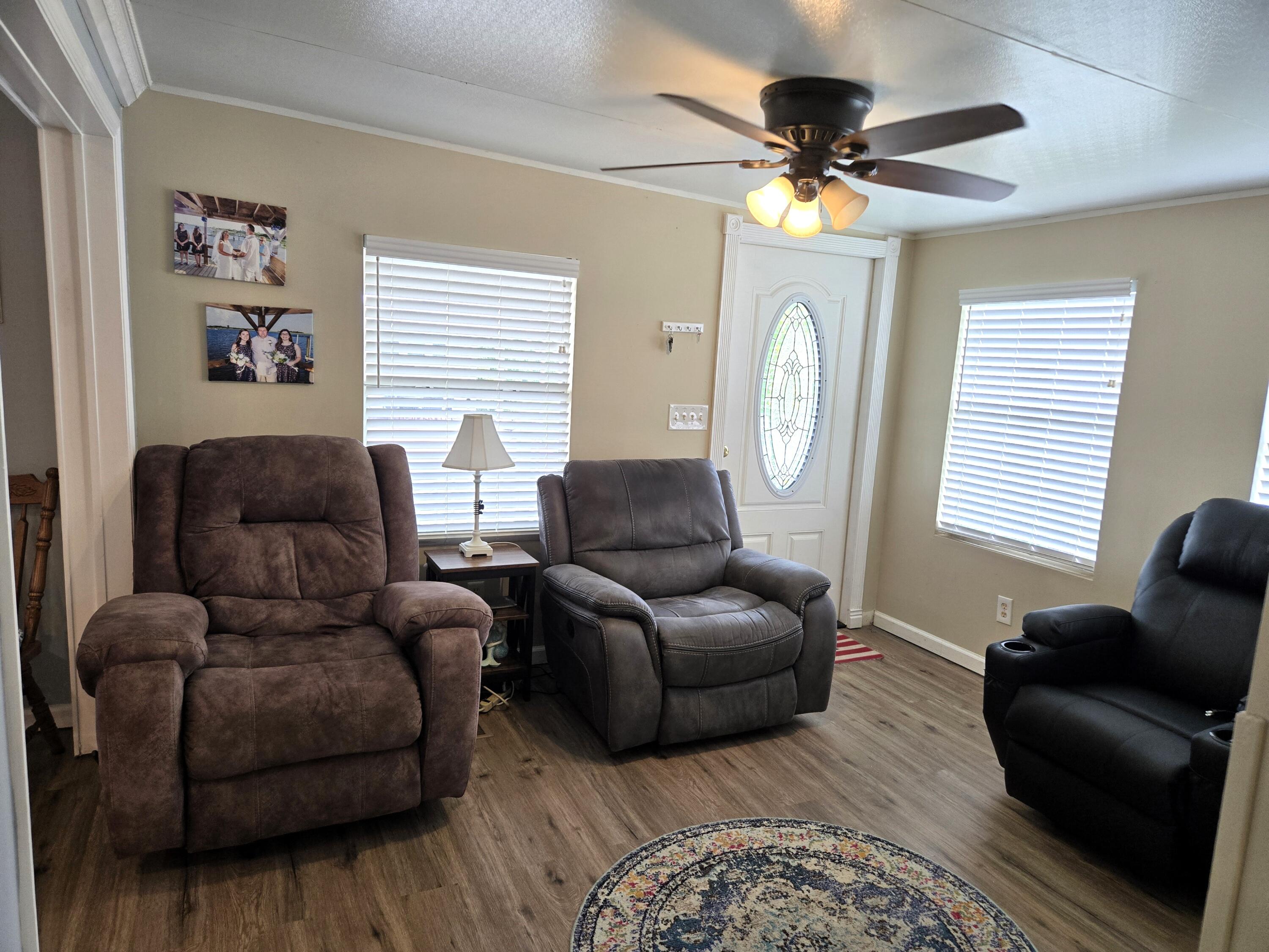 12240 Southeast 138th Avenue, Unit 225 Okeechobee, FL 34974 - Photo 3 of 50 a living room with furniture and a large window