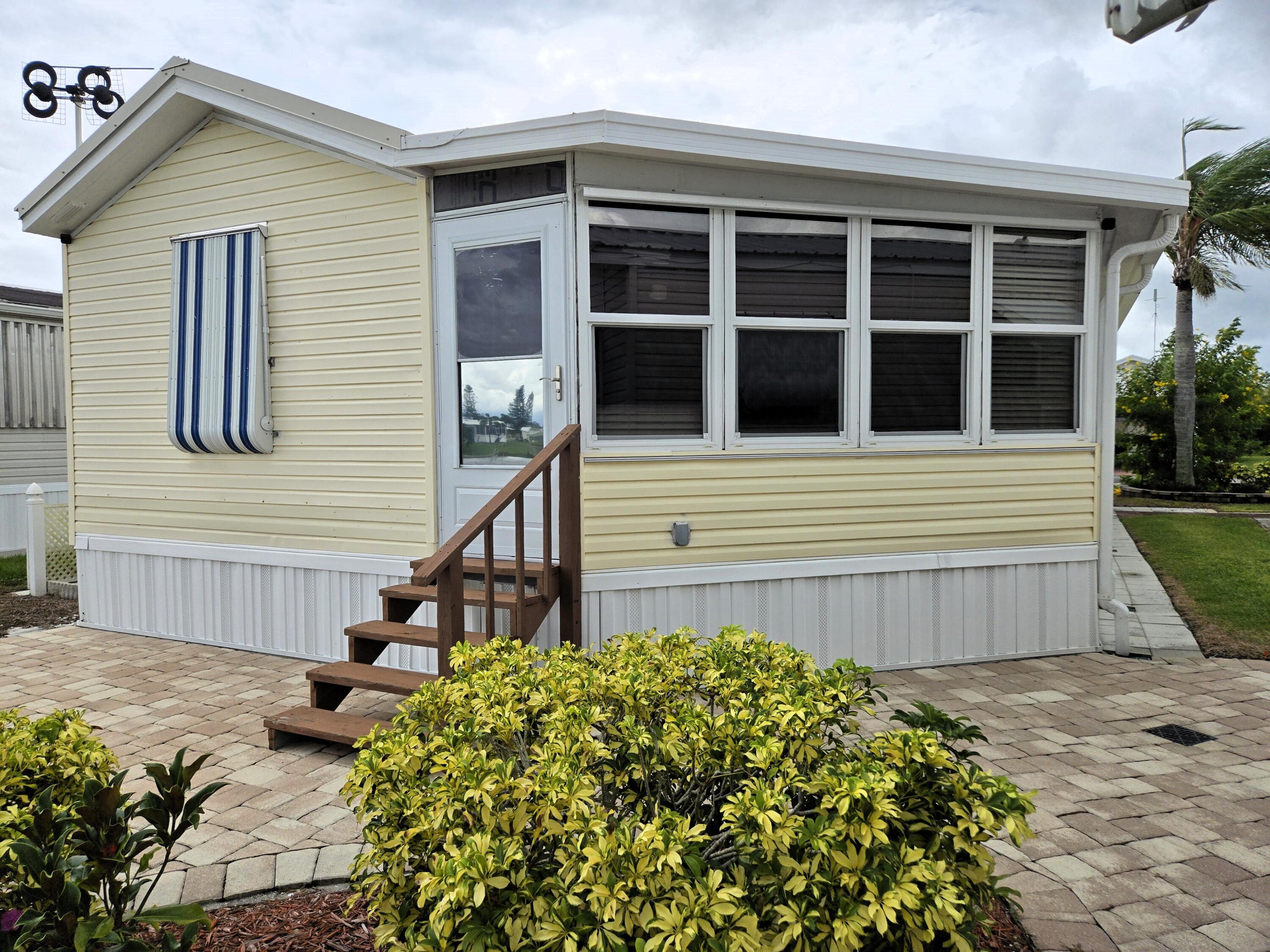 12240 Southeast 138th Avenue, Unit 225 Okeechobee, FL 34974 - Photo 34 of 50 a front view of a house with garden