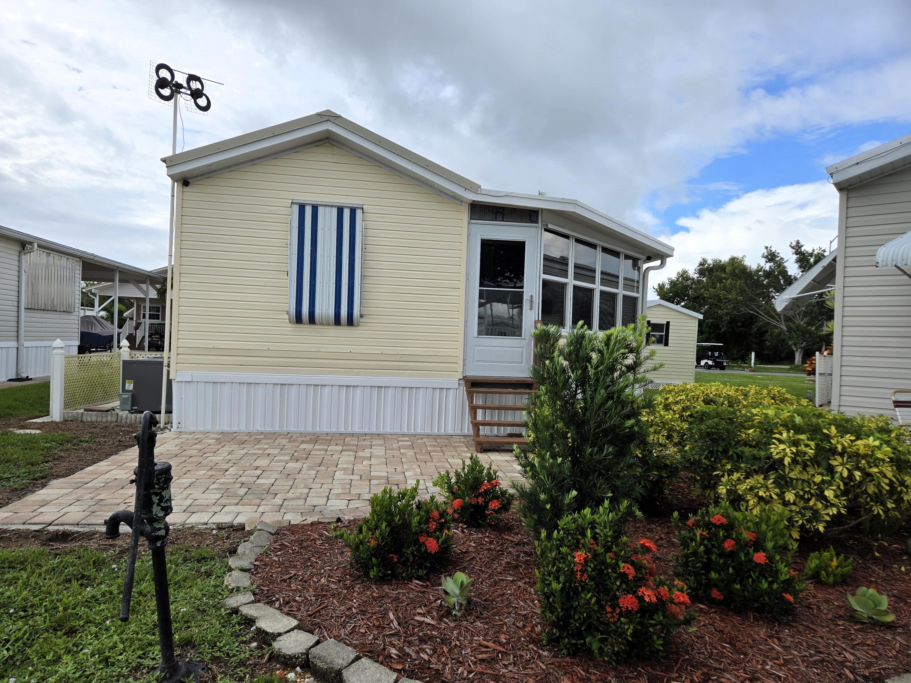 12240 Southeast 138th Avenue, Unit 225 Okeechobee, FL 34974 - Photo 36 of 50 a front view of a house with garden
