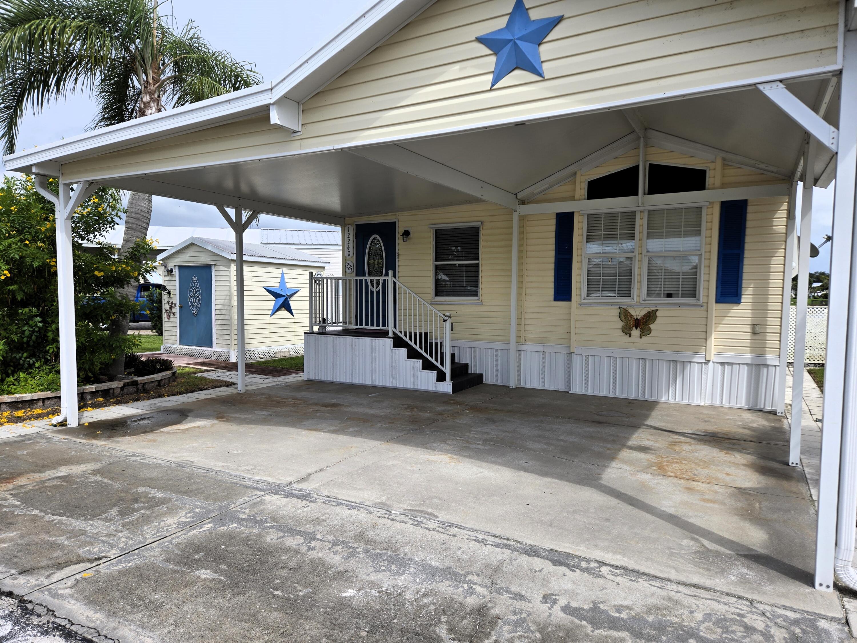 12240 Southeast 138th Avenue, Unit 225 Okeechobee, FL 34974 - Photo 40 of 50 a view of a house with porch and windows