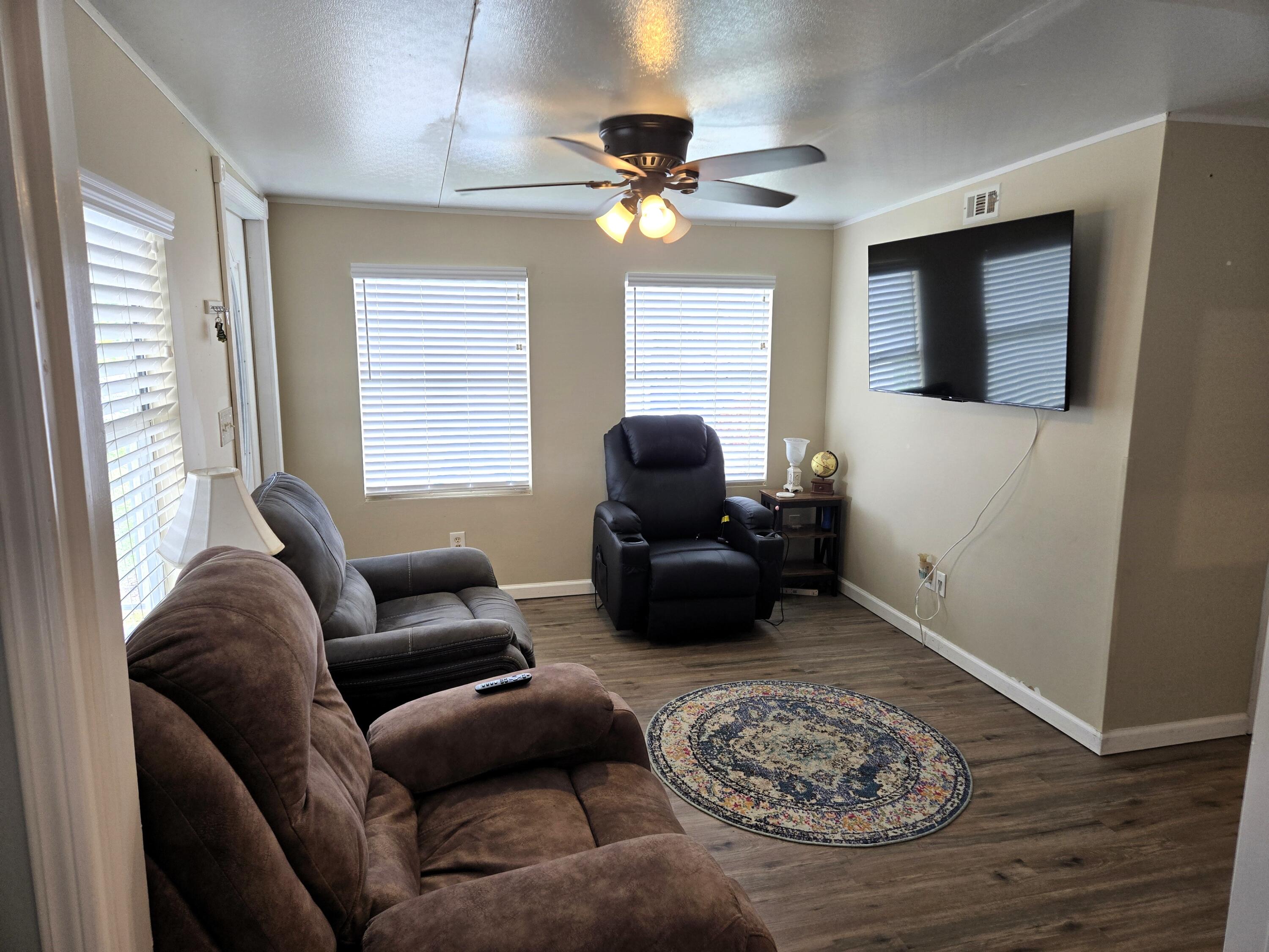 12240 Southeast 138th Avenue, Unit 225 Okeechobee, FL 34974 - Photo 4 of 50 a living room with furniture and a window