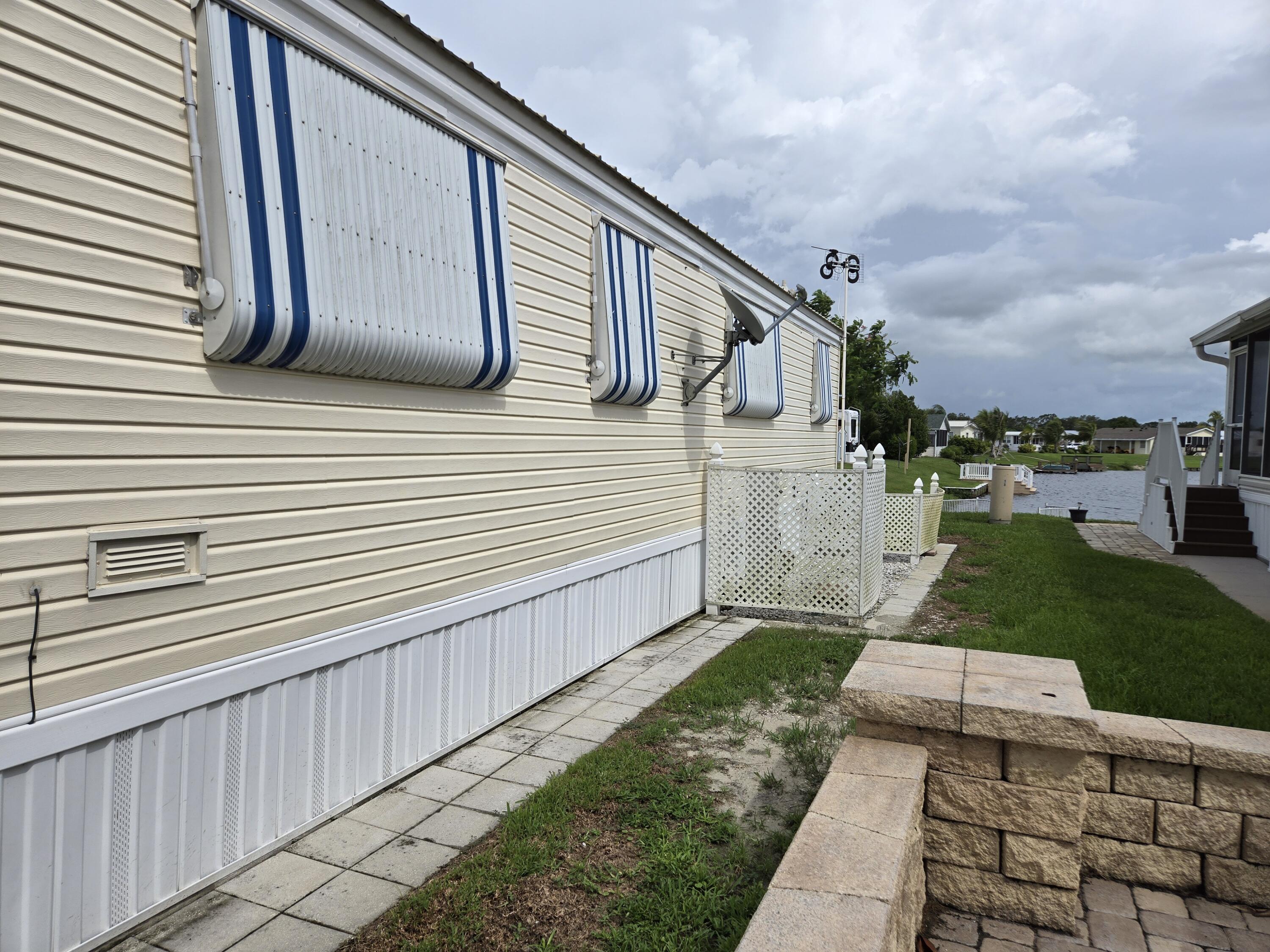 12240 Southeast 138th Avenue, Unit 225 Okeechobee, FL 34974 - Photo 41 of 50 a view of a back yard of the house
