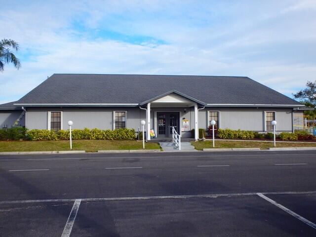 12240 Southeast 138th Avenue, Unit 225 Okeechobee, FL 34974 - Photo 43 of 50 a front view of a house with a yard and porch