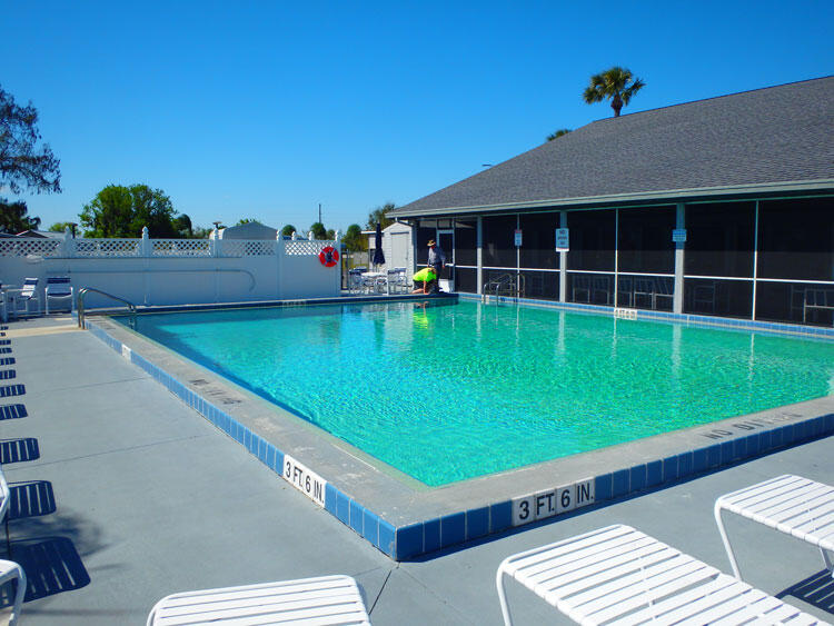 12240 Southeast 138th Avenue, Unit 225 Okeechobee, FL 34974 - Photo 44 of 50 a view of swimming pool with seating area and furniture
