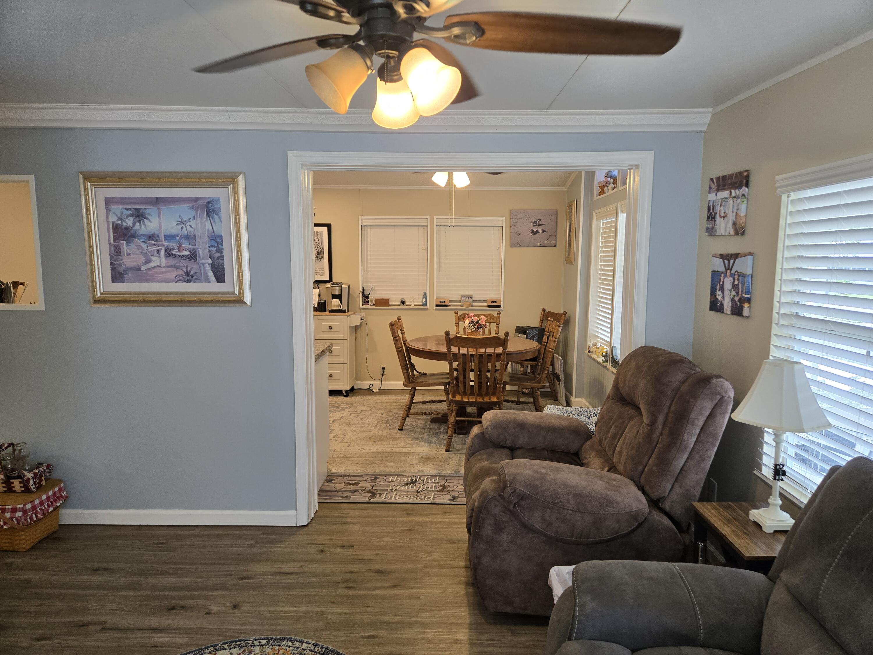 12240 Southeast 138th Avenue, Unit 225 Okeechobee, FL 34974 - Photo 5 of 50 a living room with furniture and a large window