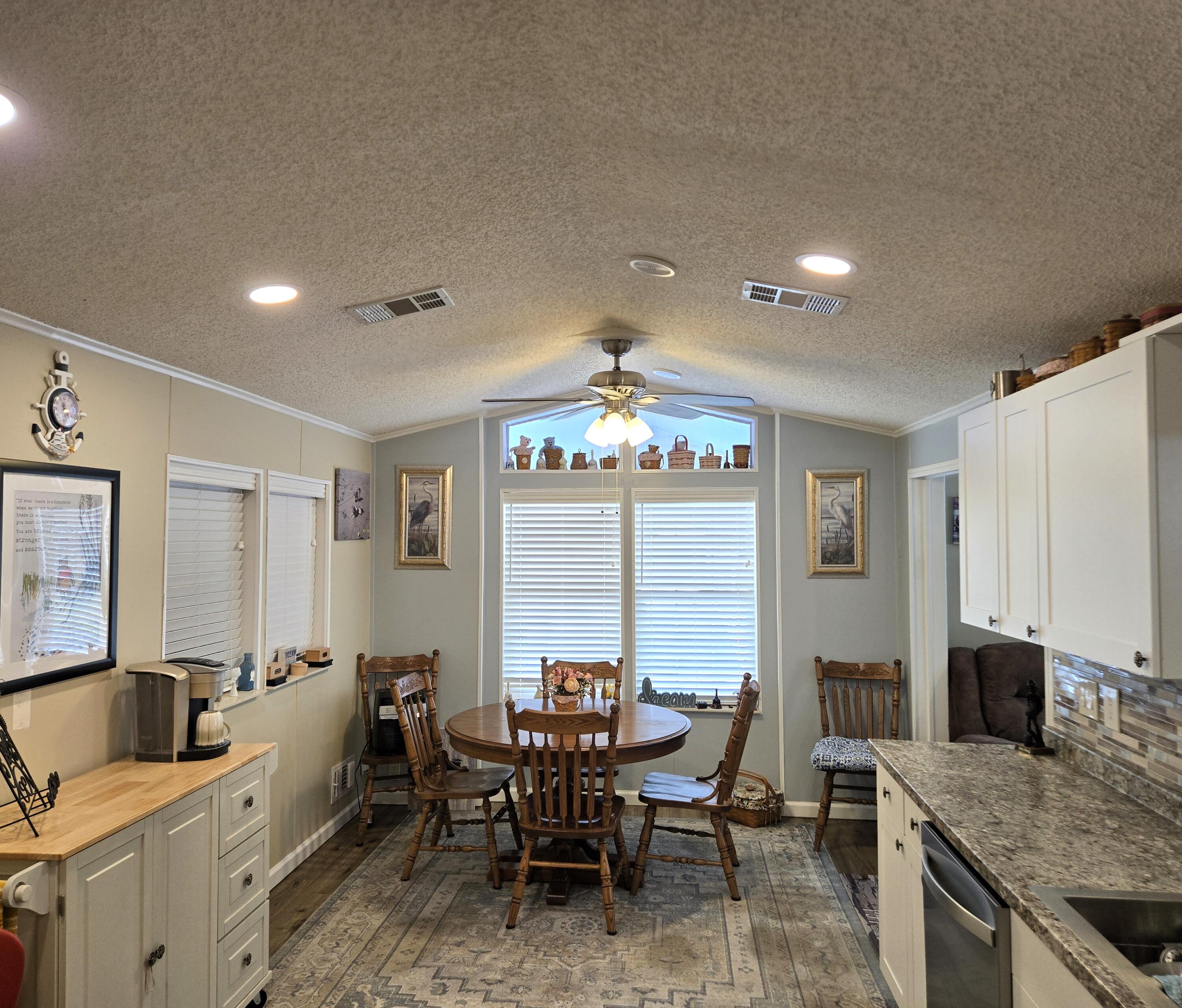12240 Southeast 138th Avenue, Unit 225 Okeechobee, FL 34974 - Photo 8 of 50 a large kitchen with a table and chairs