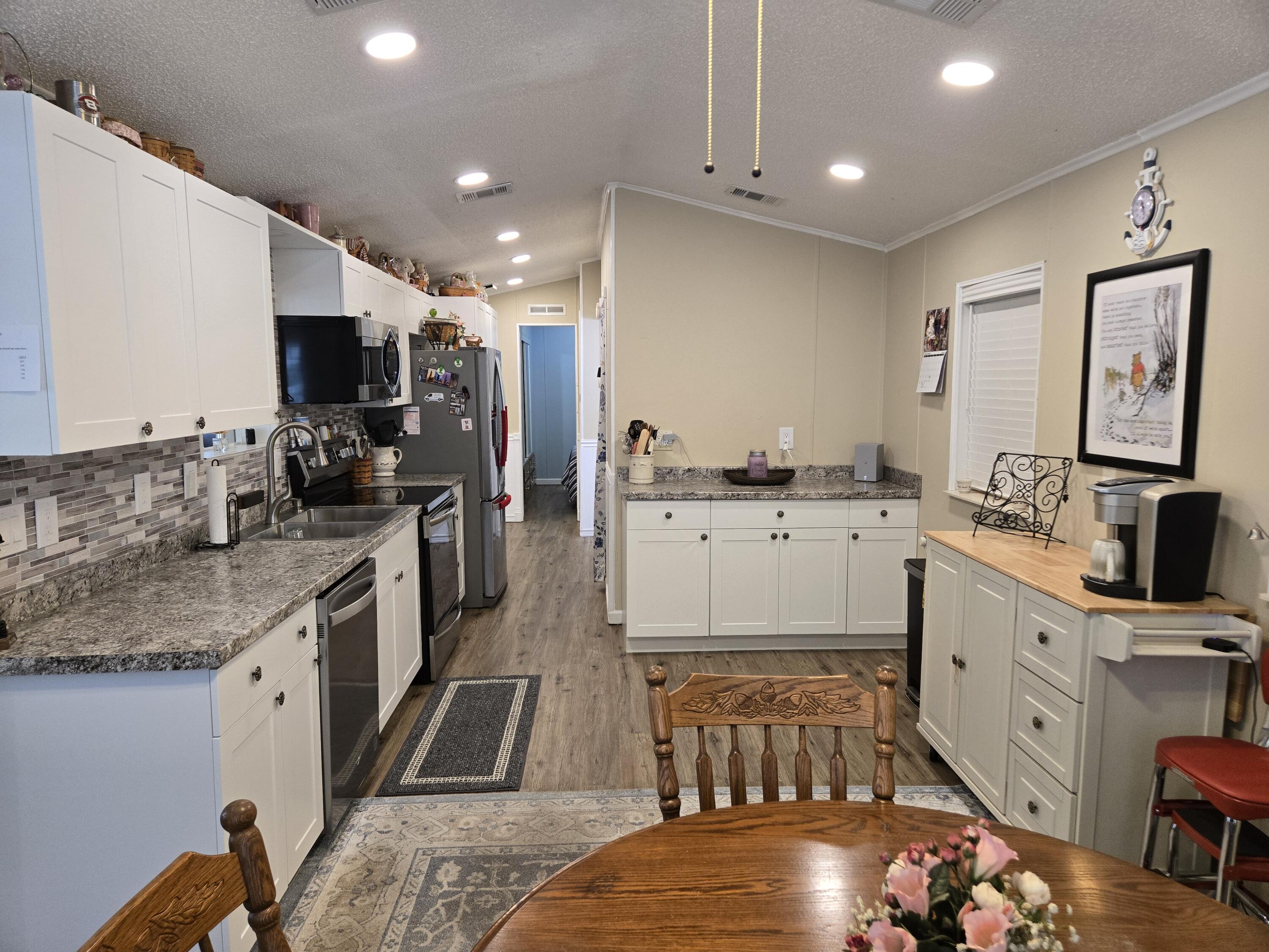 12240 Southeast 138th Avenue, Unit 225 Okeechobee, FL 34974 - Photo 10 of 50 a kitchen with stainless steel appliances granite countertop a sink stove and cabinets