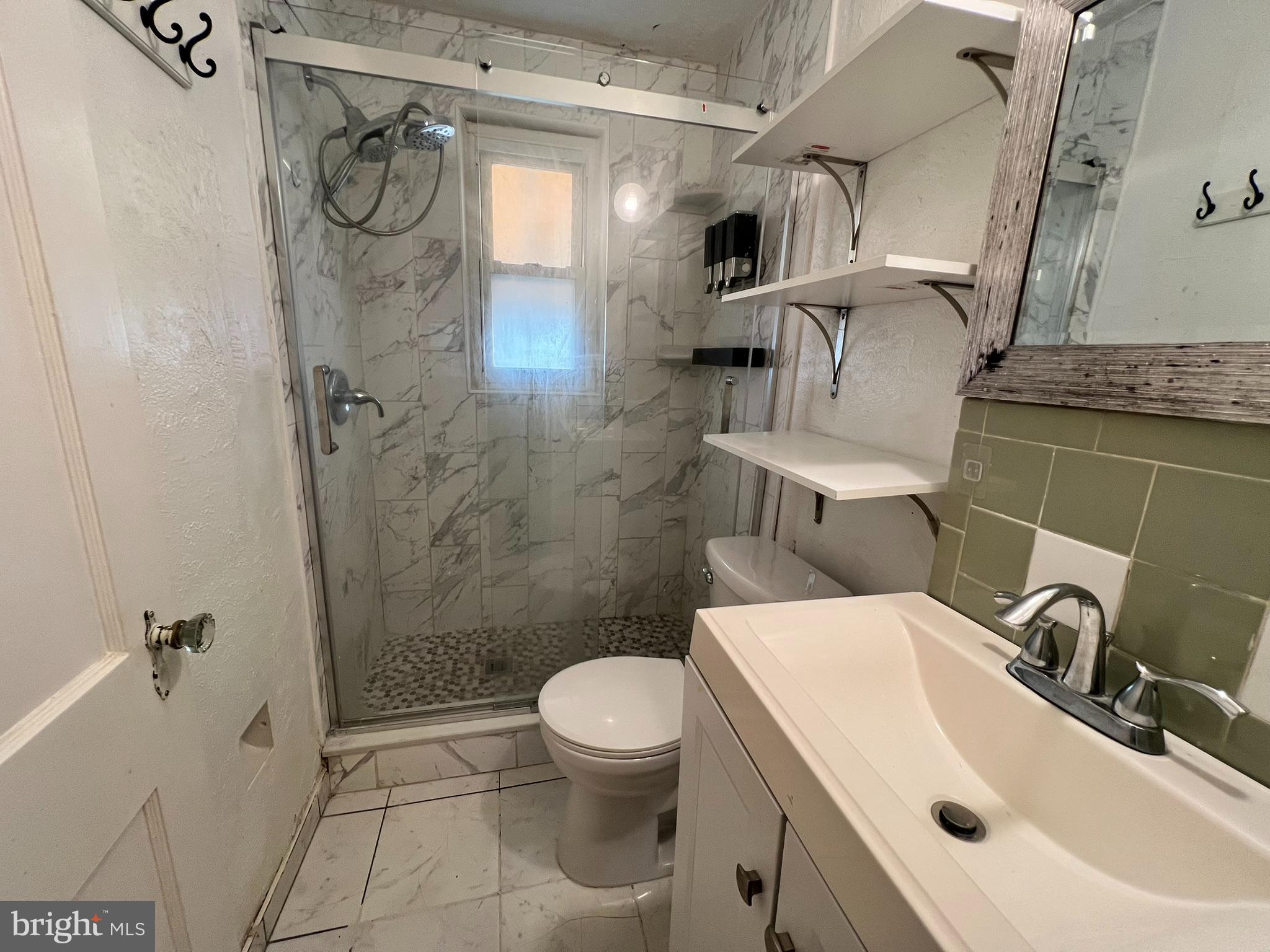 218 Springton Road Upper Darby, PA 19082 - Photo 8 of 18 a bathroom with a sink toilet and shower