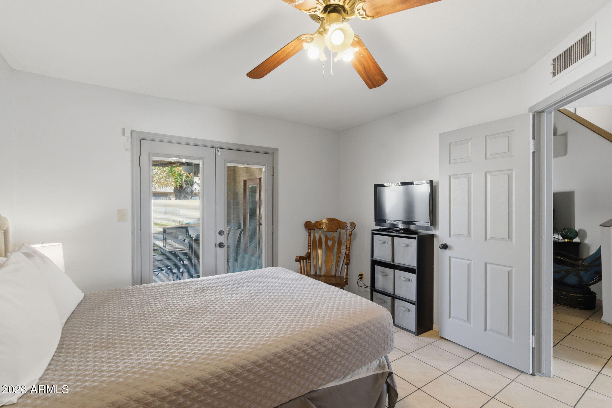 4218 West Boca Raton Road Phoenix, AZ 85053 - Photo 16 of 27 a bedroom with a bed and a chandelier