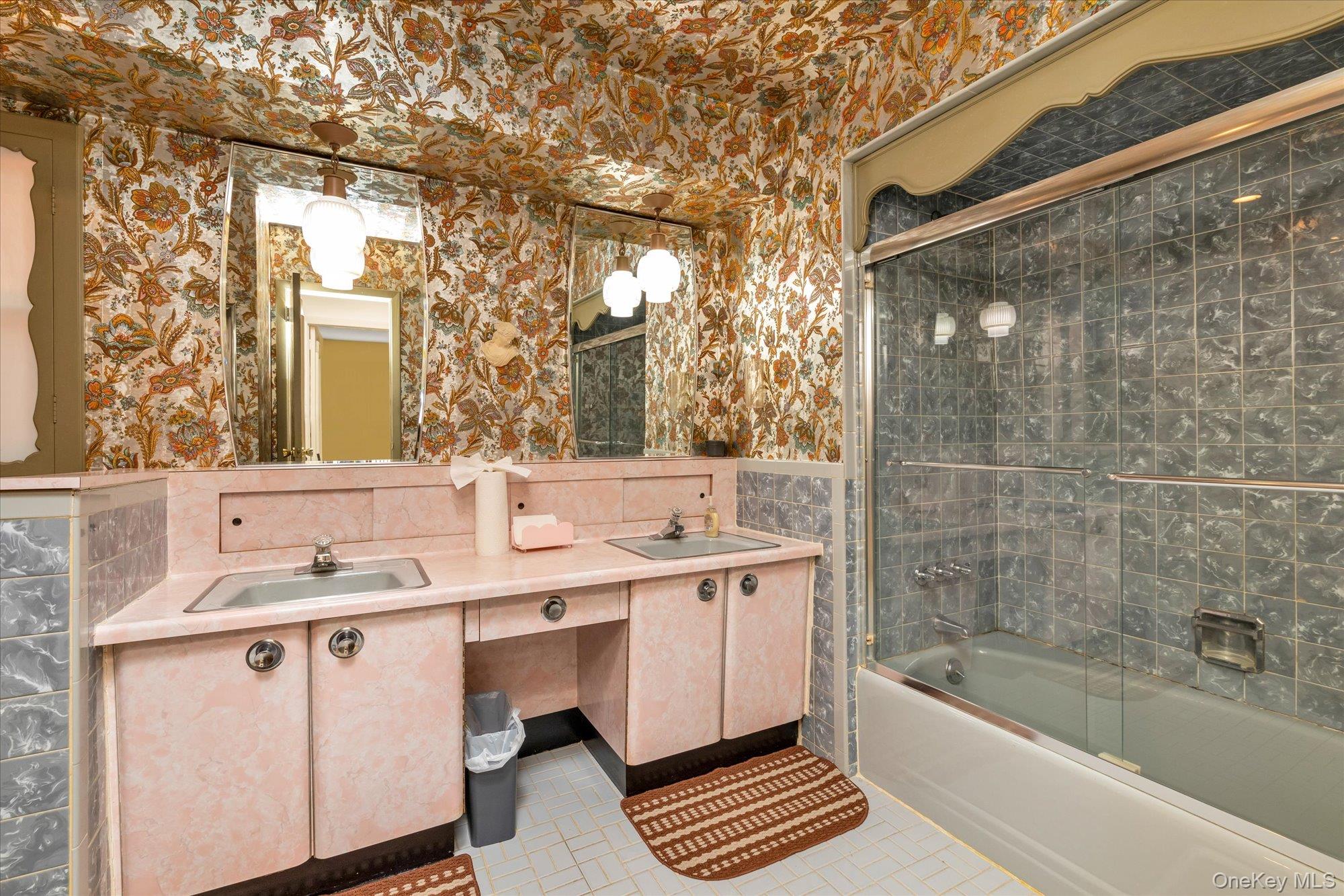 180 Dogwood Road Roslyn, NY 11576 - Photo 13 of 21 a bathroom with a sink a mirror and a bathtub