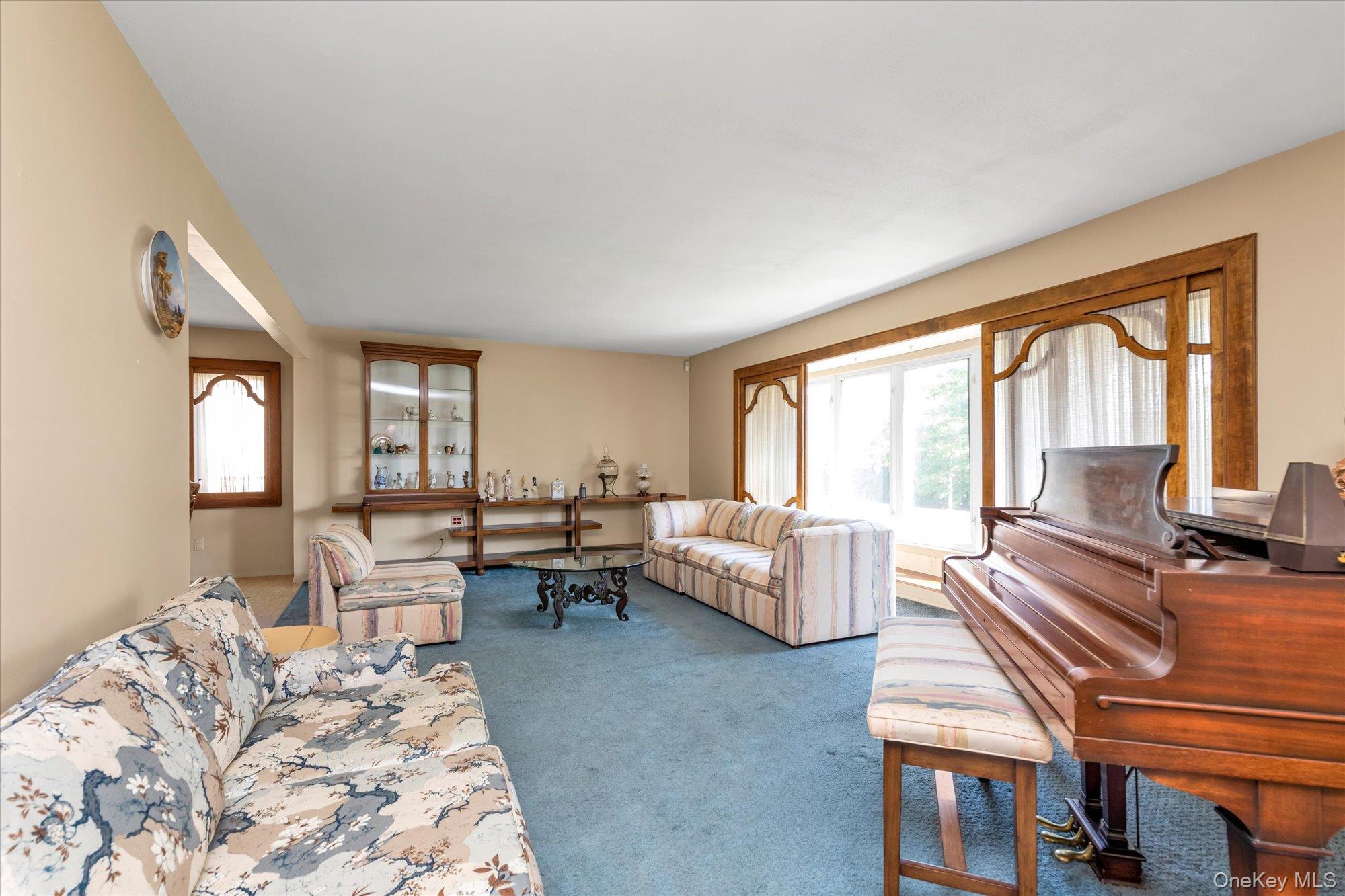 180 Dogwood Road Roslyn, NY 11576 - Photo 3 of 21 a living room with furniture and large windows