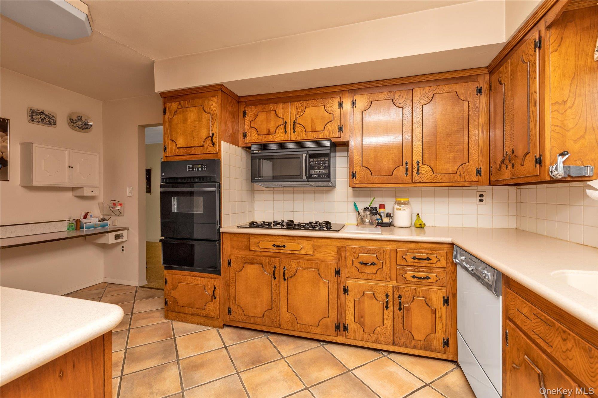 180 Dogwood Road Roslyn, NY 11576 - Photo 5 of 21 a kitchen with stainless steel appliances granite countertop a refrigerator sink and cabinets