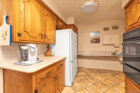 a kitchen with a sink a stove and a refrigerator