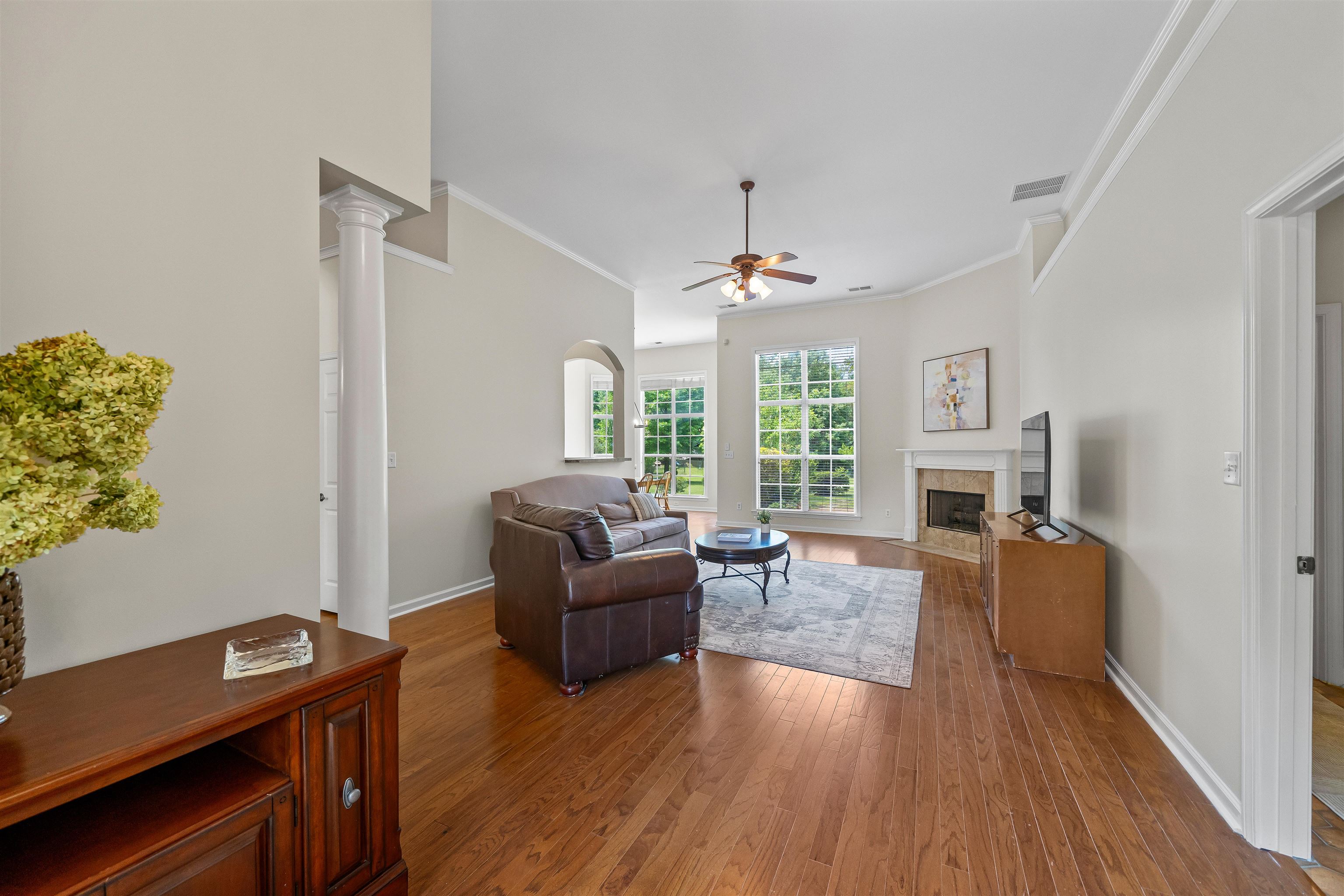5035 Brian Ridge Road Arlington, TN 38002 - Photo 11 of 40 Spacious living area featuring wood-finish flooring, a ceiling fan, and large windows