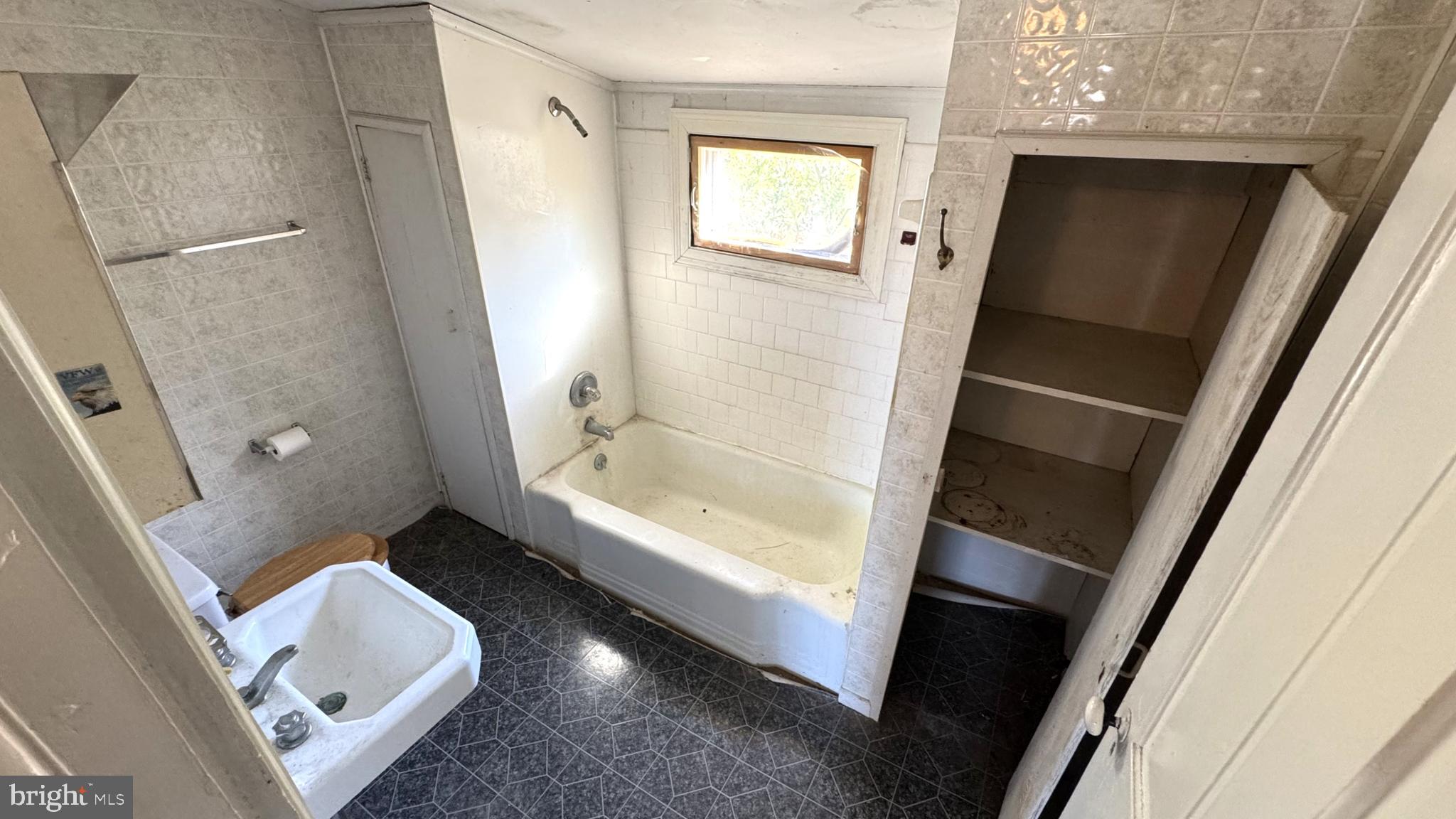 28207 Nanticoke Road Salisbury, MD 21801 - Photo 17 of 26 a bathroom with a tub shower and toilet