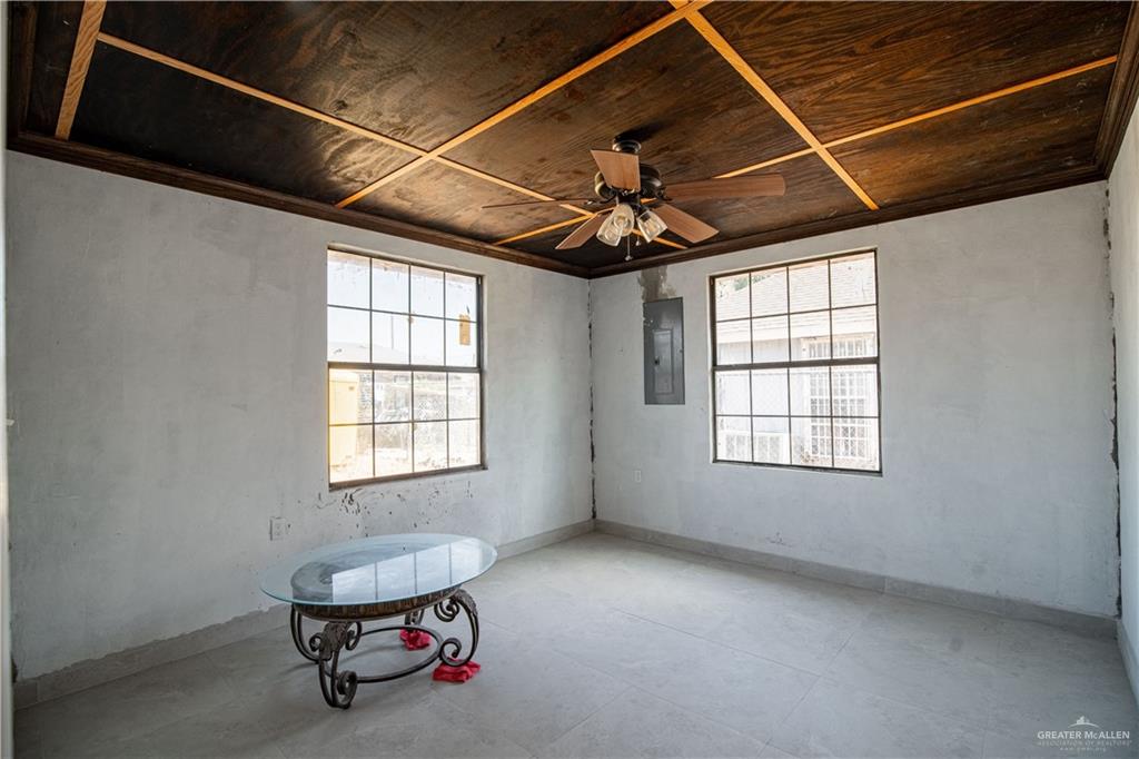 6707 South Rivera Street Pharr, TX 78577 - Photo 14 of 17 Unfurnished room with wood ceiling, electric panel, a ceiling fan, and ornamental molding