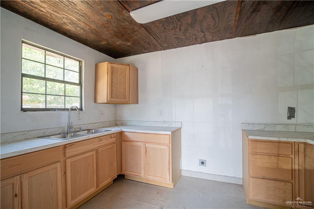 6707 South Rivera Street Pharr, TX 78577 - Photo 5 of 17 Kitchen with light countertops, light brown cabinetry, light tile patterned flooring, and wood ceiling