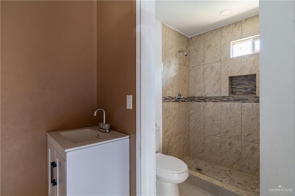 6707 South Rivera Street Pharr, TX 78577 - Photo 10 of 17 Bathroom with a tile shower and vanity