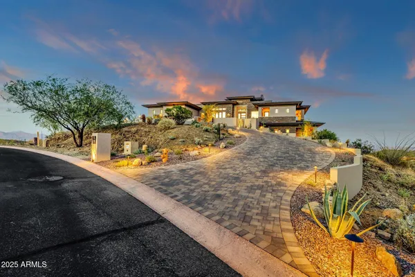 a view of a house with large outdoor space and sitting area