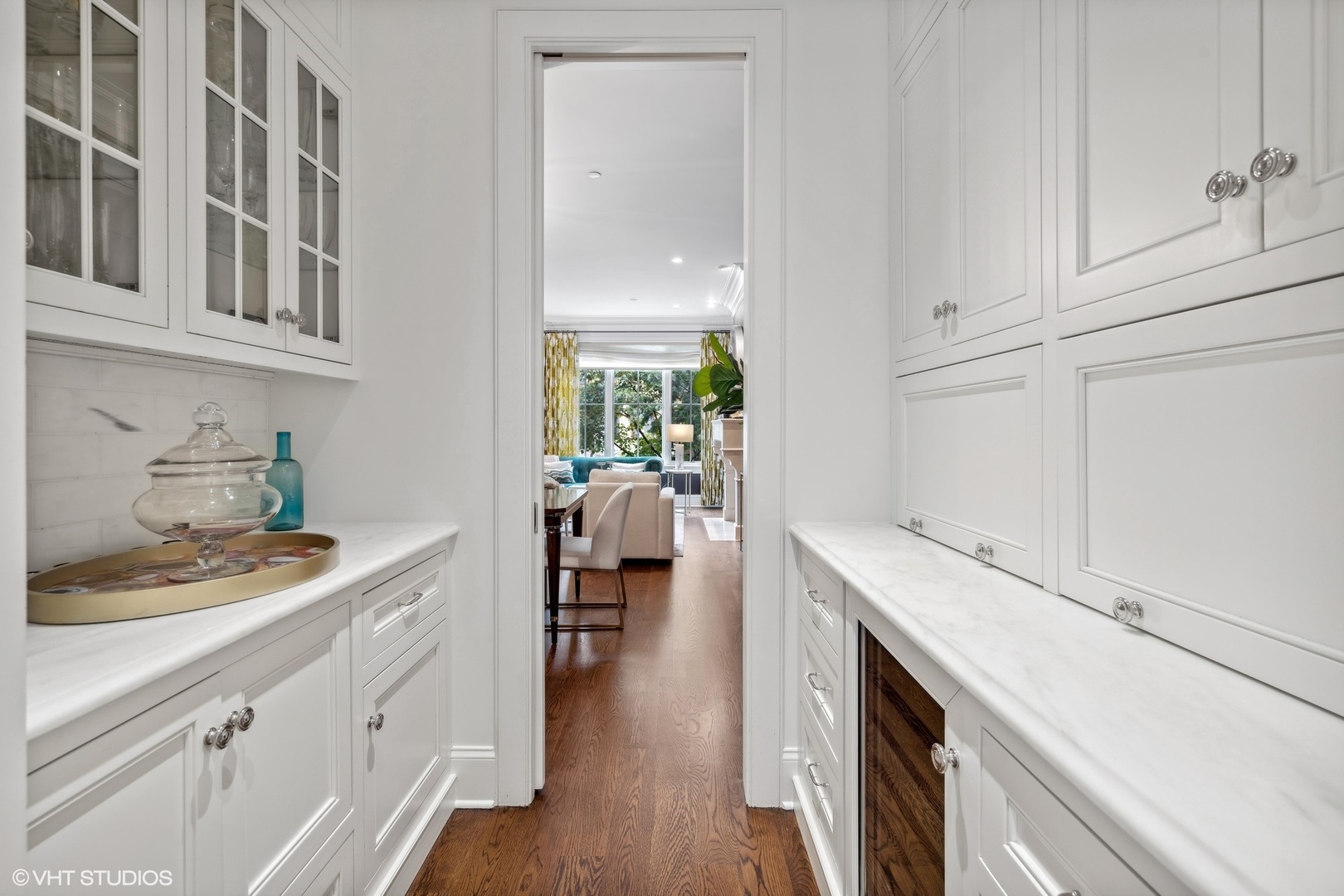 3740 North Wayne Avenue Chicago, IL 60613 - Photo 11 of 55 a kitchen with a sink dishwasher stove and white cabinets with wooden floor