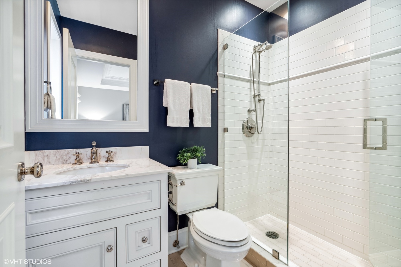3740 North Wayne Avenue Chicago, IL 60613 - Photo 27 of 55 a bathroom with a sink toilet vanity and shower