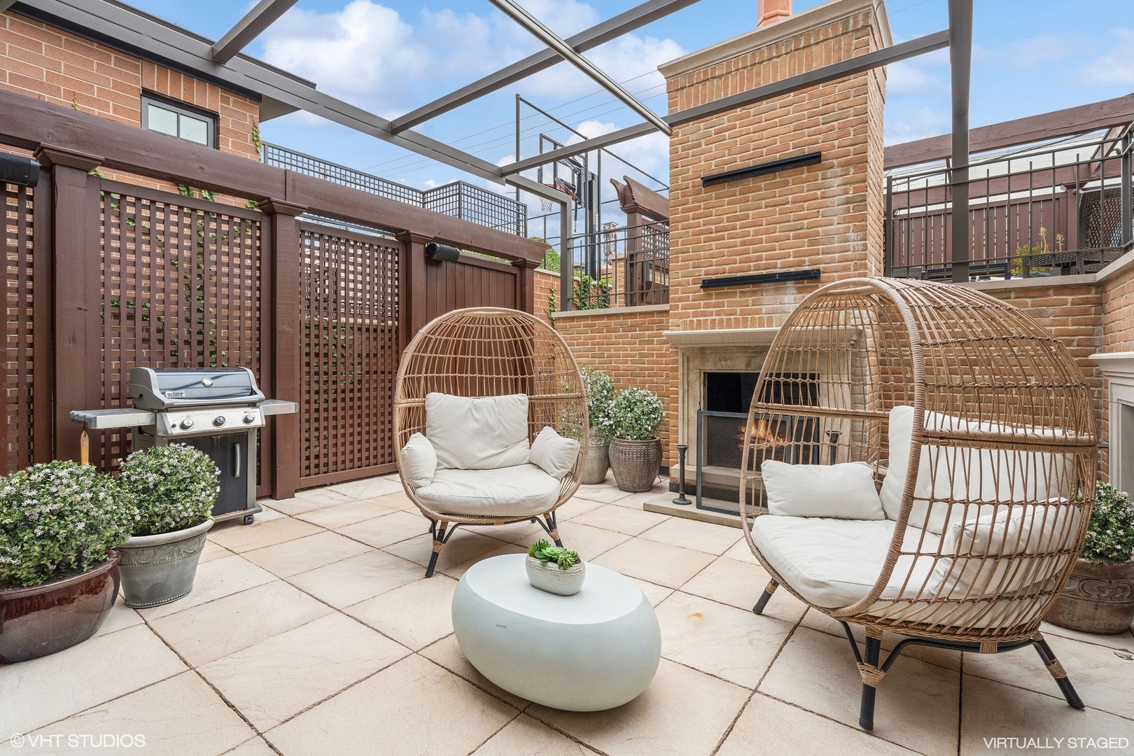 3740 North Wayne Avenue Chicago, IL 60613 - Photo 49 of 55 a view of a patio with couches table and chairs and potted plants