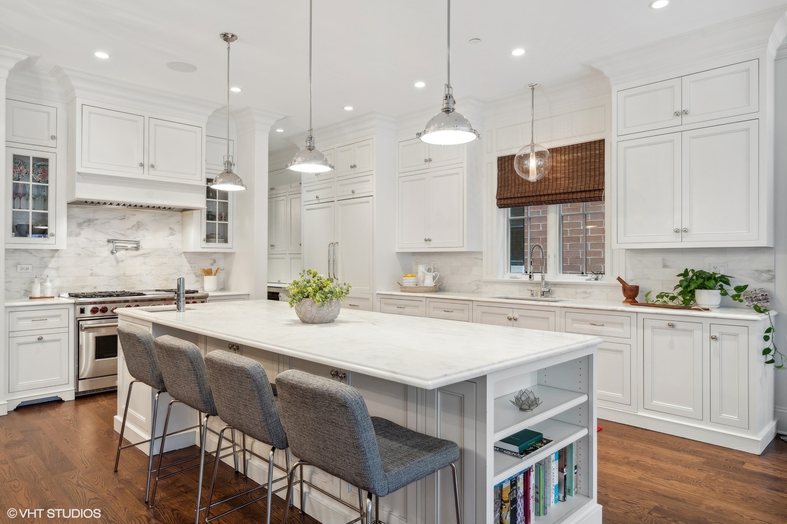 3740 North Wayne Avenue Chicago, IL 60613 - Photo 8 of 55 a kitchen with kitchen island a stove a table and chairs in it