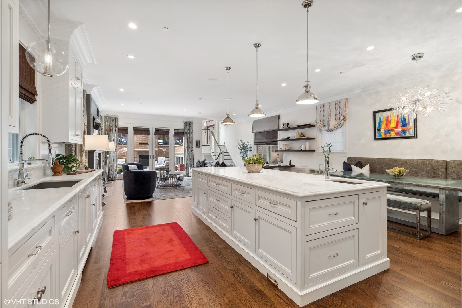 3740 North Wayne Avenue Chicago, IL 60613 - Photo 9 of 55 a large kitchen with kitchen island a stove a sink dishwasher a oven and a dining table with wooden floor