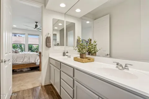 a en suite bathroom with a double vanity sink and a large mirror