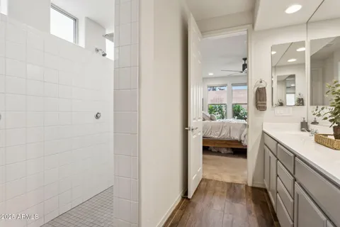a en suite bathroom with a sink a mirror and a shower