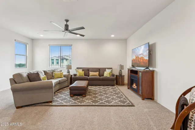 a living room with furniture a rug and a chandelier