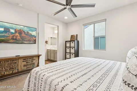 a bedroom with a bed and a painting on the wall