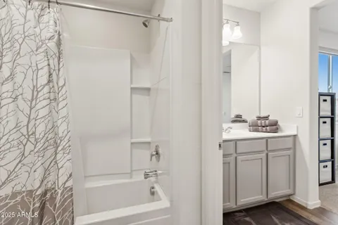 a bedroom with a bed and ceiling fan