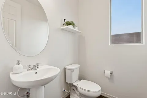 a bathroom with a sink a mirror and a toilet